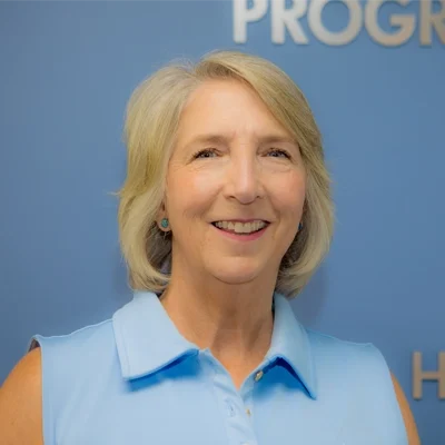 Michelle Liberty smiling in a blue shirt.